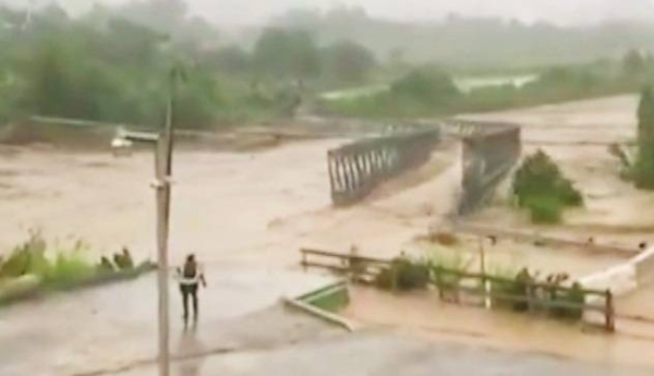 Hurricane Fiona flood water destroys a Puerto Rican bridge.