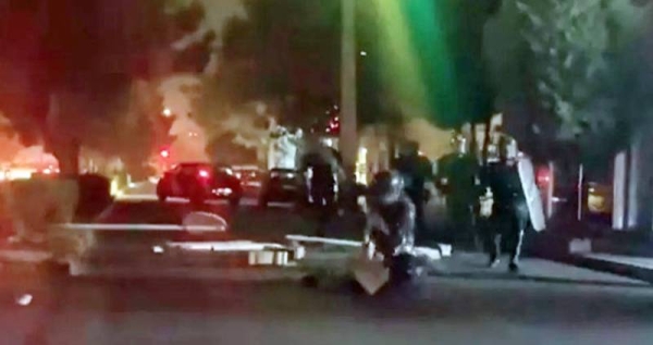A video posted on social media purportedly shows riot police beating an unarmed woman. — courtesy Twitter