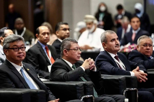 Malaysian Foreign Minister Saifuddin Abdullah (second left) attends the international seminar.