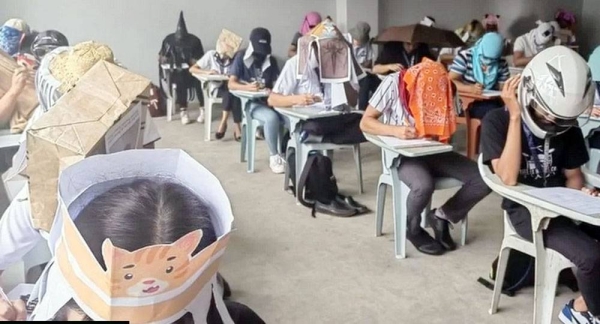 Students wear homemade “anti-cheating hats” in a classroom in the Philippines, — courtesy Mary Joy Mandane-Ortiz