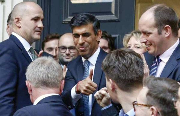 Rishi Sunak — after his first televised address as Tory leader — leaves the Conservative HQ smiling and with a wave to the small crowd that had gathered.