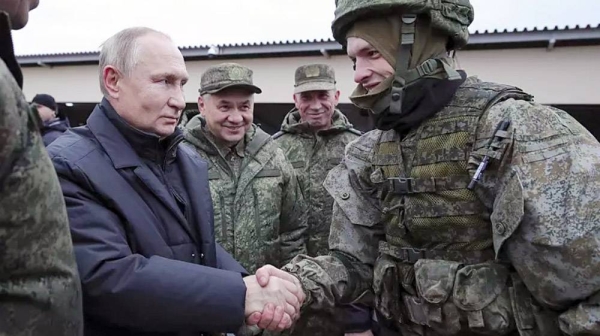 Russian President Vladimir Putin shakes hands with a soldier as he visits a military training center of the Western Military District, 20 October 2022. — courtesy Mikhail Klimentyev, Sputnik, Kremlin Pool Photo
