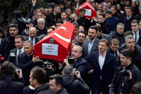 
Mourners from the Turkish community carry the bodies of the victims of Sunday’s explosion on Istanbul’s popular pedestrian Istiklal Avenue for burial.