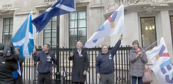 Pro-independence protester hold a Saltire (Scottish flag) during a rally. — courtesy photo