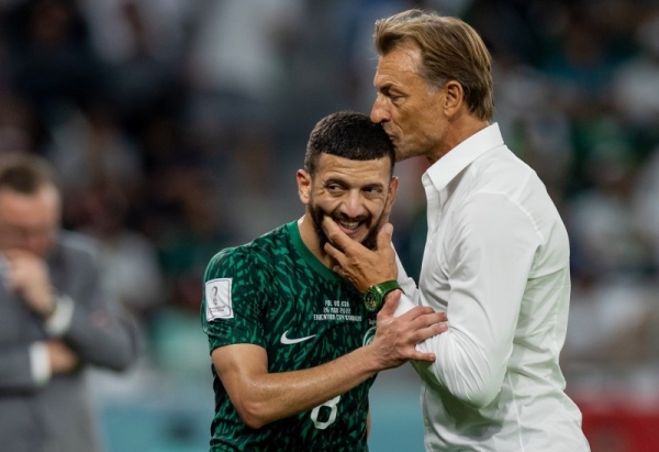 Saudi Arabia's Coach Hervé Renard consoles defender Abdulelah Al-Maliki after his defensive lapse resulted in Poland’s second goal. 