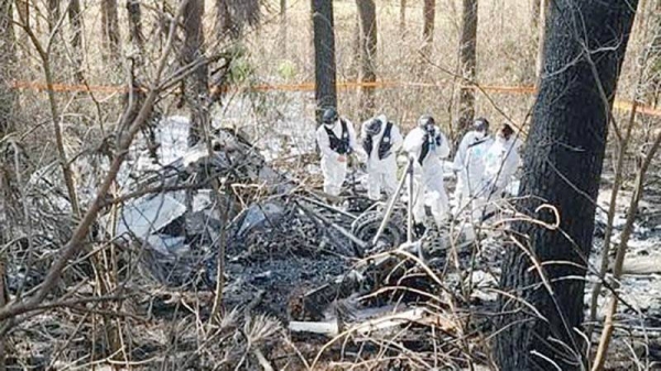 Rescue workers scour the area where a helicopter crashed in the eastern coastal county of Yangyang in South Korea. — courtesy photo