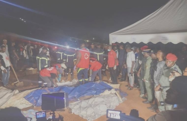 Rescuers prepare to carry a body after the landslide.