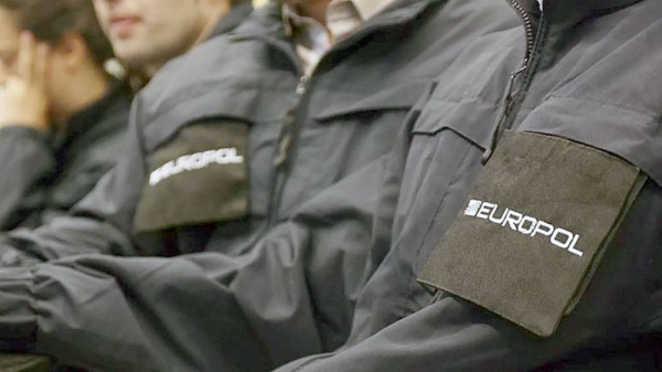 Operatives wearing uniforms with the logo of Europol. — courtesy Europol