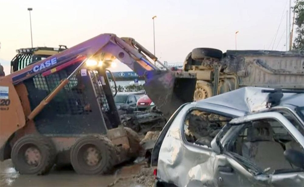 The remains of cars and buses crushed by the violent mudslide and rockslide can be seen everywhere as excavators try to clear access to homes, cars and shops.