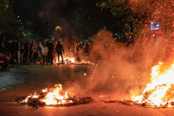 Burning trash bins outside the Ippokrateio General Hospital in the Greek city of Thessaloniki on Monday night