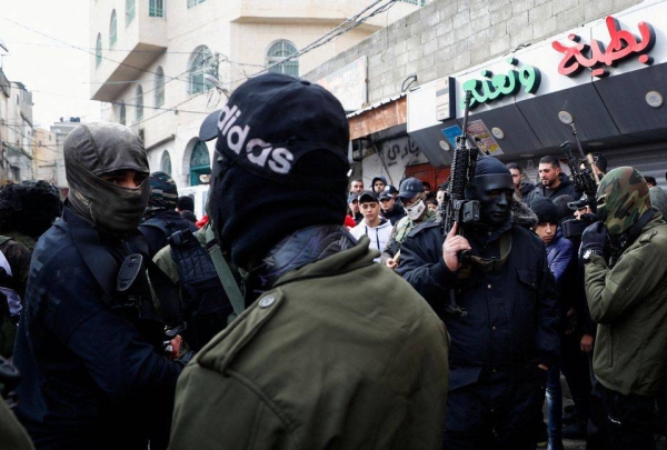 Palestinian militants from the al-Aqsa Martyrs Brigades attend the funeral of Mohammad Abbas who was shot dead by Israeli forces in Ramallah in December last year. (file photo)