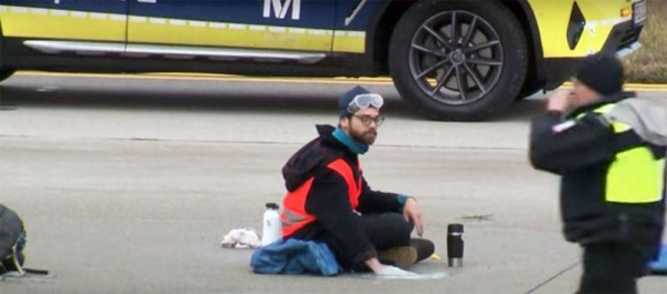 Activists protesting against cheap air travel glued themselves to Munich airport's runway. — courtesy photo YouTube