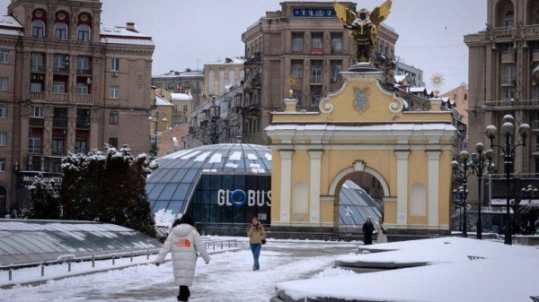 People walk in the Independence square in central Kyiv, Ukraine, Monday.
