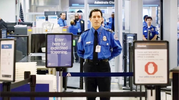 TSA security officer stands at a check point. — courtesy Getty Images