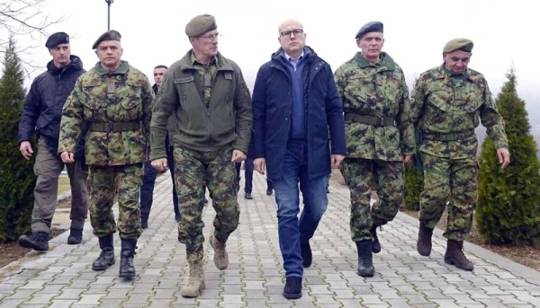 Serbia Defense Minister Milos Vucevic (center) speaks with Serbian army chief of staff Milan Mojsilovic (center left) in southern Serbia near the Kosovo border on Monday. — courtesy Serbian Presidential Press Service via AP Photo