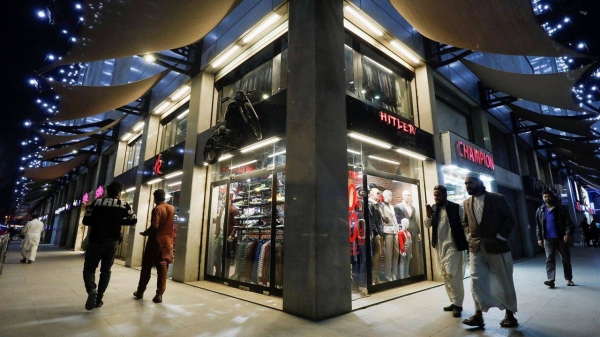 People walk outside shops at the Atrium Mall in Karachi.