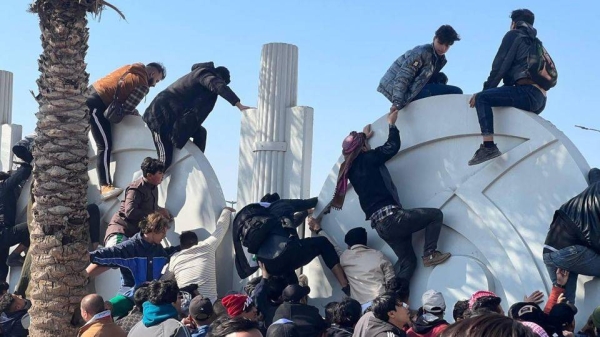 Soccer fans attempt to enter the stadium to watch the final match of the 25th Arabian Gulf Cup between Iraq and Oman, in Basra, Iraq Thursday.