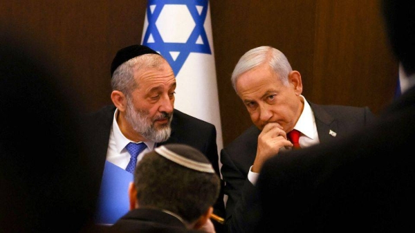 Israel's Prime Minister Benjamin Netanyahu, right, sits next to Interior and Health Minister Aryeh Deri during a weekly cabinet meeting on January 8, 2023.