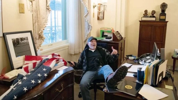 Richard Barnett with his feet on the then Speaker US Democrat Nancy Pelosi’s desk. — courtesy Getty Images