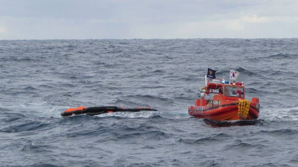 A South Korea Coast Guard vessel searches for crew from a capsized ship in waters between South Korea and Japan on January 25, 2023.