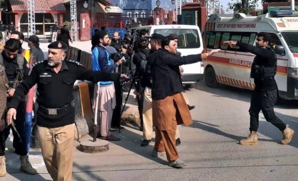 Police officers clear the route for ambulances carrying wounded people from the scene of blast.