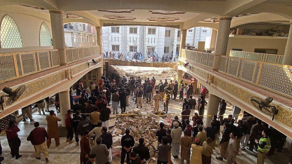 Security officials inspect the site of the mosque attack in Peshawar.