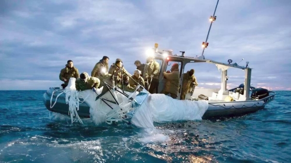 Balloon being hauled into boat. —courtesy US Fleet Forces Command