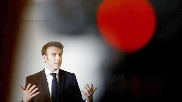 French President Emmanuel Macron gestures as he talks with schoolchildren in a classroom in Jarnac. — courtesy AFP