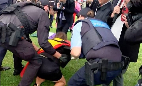 Australian senator Lidia Thorpe ends up on ground during a scuffle with police.