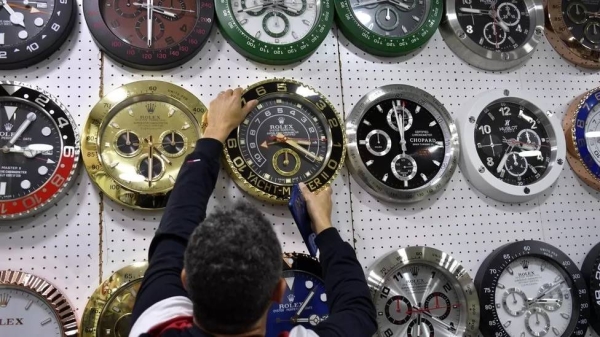 A man changes the time at a clock and watch shop in Beirut, Lebanon. — courtesy EPA