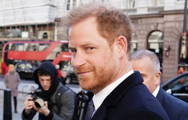 Harry bumps into photographer outside court
