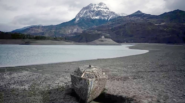 A sunken sail boat is pictured above the water line at the lake Serre-Poncon in southern France. — courtesy AP Photo/Daniel Cole