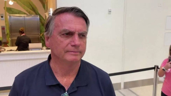 Jair Bolsonaro spoke to journalists at Orlando airport before boarding his flight home