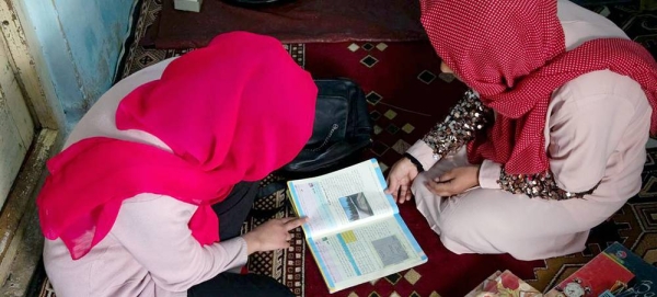 An Afghan girl studies at home with the help of her father after being denied the right to carry on studying at school. — courtesy UNICEF/Munir Tanwee/Daf recor