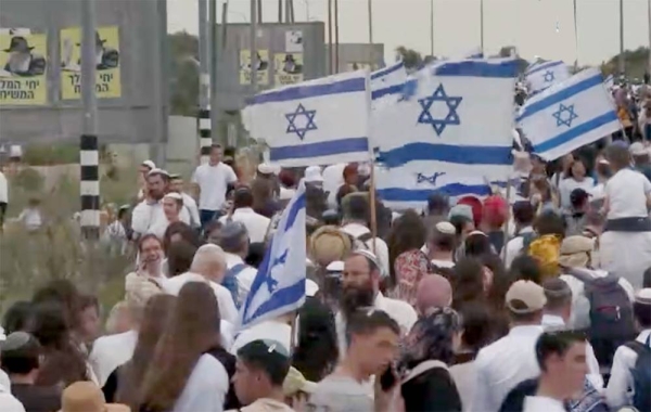 Israelis stand in outpost of Eviatar in the West Bank, Monday.