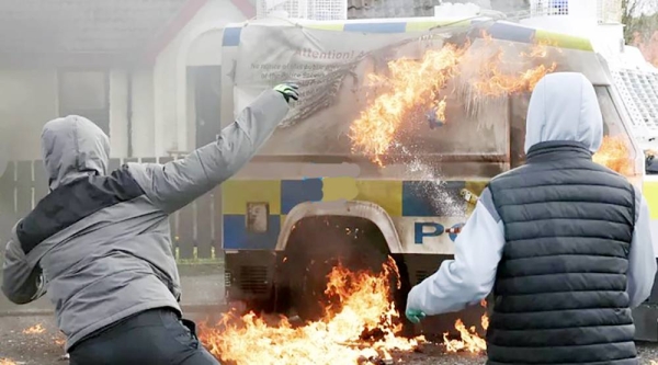 Police car firebombed in protest against Northern Ireland peace deal. — courtesy Peter Morrison/ AP.