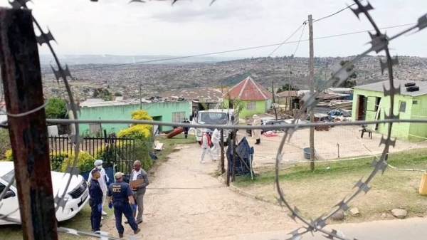 The exterior of the homestead with police and medical officials outside Pietermaritzburg, South Africa Friday. — courtesy Reuters