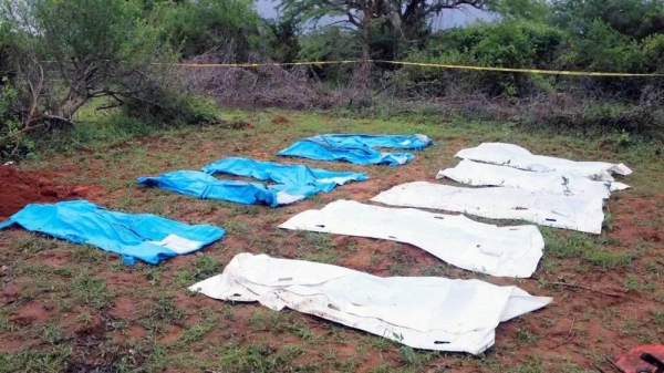 Body bags are seen arranged as forensic experts and homicide detectives exhume bodies. — courtesy Reuters