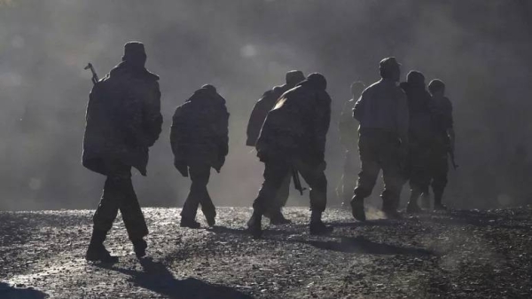 Ethnic Armenian soldiers walk along the road near the border between Nagorno-Karabakh and Armenia, Nov. 8, 2020.