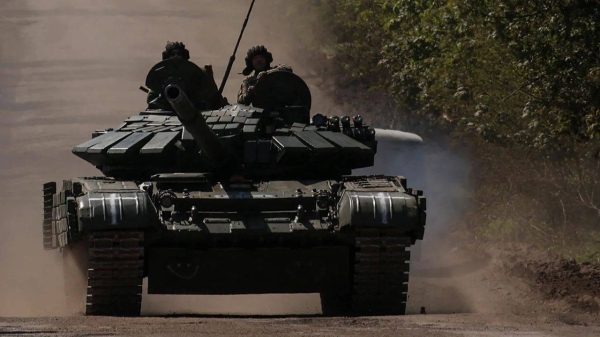 Ukrainian servicemen ride atop a tank on a road to the frontline town of Bakhmut, amid Russia's attack on Ukraine, in Donetsk region