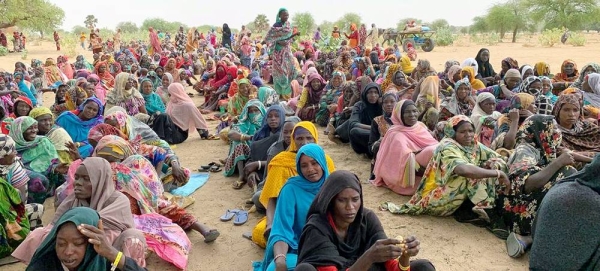 Refugees from Sudan wait to collect essential non-food items during distribution in Koufroun, a Chadian village near the Sudanese border. — courtesy UNICEF/Donaig Le Du