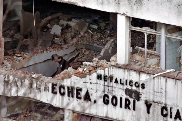 In this Feb. 22, 2006 file photo, a Basque policeman looks over the damage after a bomb exploded outside a cannery in an industrial area of Bilbao, northern Spain.