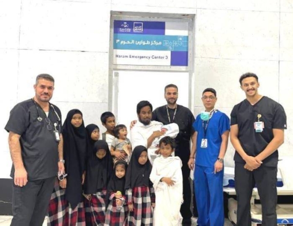 Makkah Haram Emergency Center doctors and staff pose for a photo with the newborn baby and family members of the Singaporean Umrah pilgrim.  