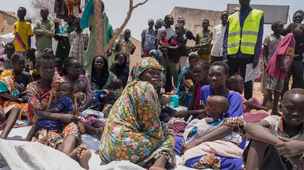 South Sudanese who fled from Sudan sit outside a nutrition clinic at a transit center in Renk, South Sudan, on May 16, 2023