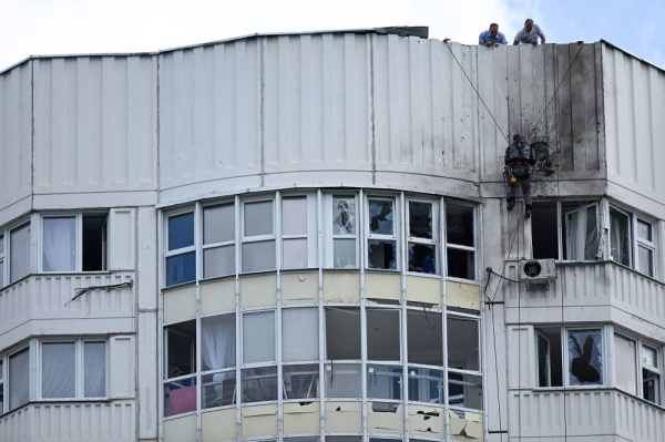 A specialist inspects the damaged facade of a multi-storey apartment building after a reported drone attack in Moscow on May 30, 2023. (Photo by Kirill KUDRYAVTSEV / AFP) (Photo by KIRILL KUDRYAVTSEV/AFP via Getty Images)