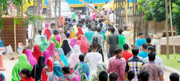 Bangladeshi garment employees leave a clothing plant at the end of their working day. — courtesy ILO/ Marcel Crozet