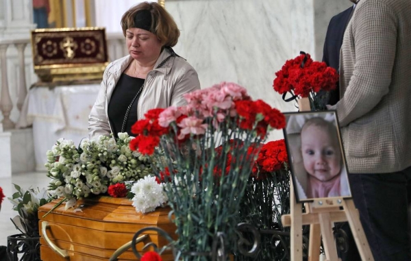 ODESA, UKRAINE - APRIL 27, 2022 - Relatives and friends are present during the funeral service of Valeriia Hlodan, her three-month-old baby girl Kira and her mother Liudmyla Yavkina at Transfiguration Cathedral, Odesa, southern Ukraine. The women and an infant were killed after one of the Russian cruise missiles launched against Odesa hit an apartment block on April 23, 2022. (Photo credit should read Nina Liashonok/ Ukrinform/Future Publishing via Getty Images)