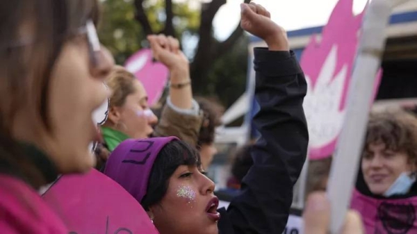 People shout slogans during a demonstration against violence on women, in Rome, Saturday, Nov. 27, 2021.