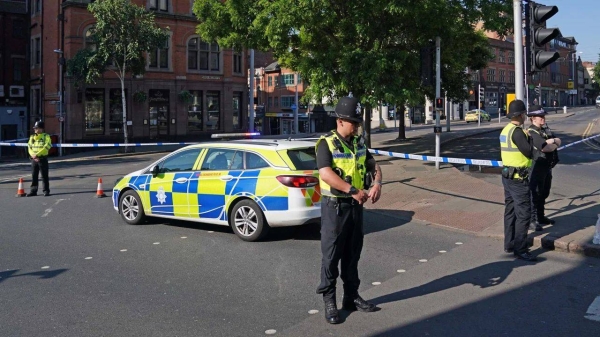 Police officers line a street in Nottingham on Tuesday, where multiple road closures were in place as authorities deal with what they called a major incident