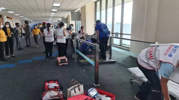 A medical team attends to the woman whose leg was trapped in a travelatorImage source, Don Mueang International Airport